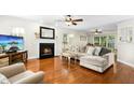 Bright living room with fireplace, hardwood floors, and comfortable seating area at 8513 Buscot Ct, Raleigh, NC 27615
