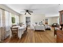 Bright dining room featuring hardwood floors and an open layout to the living area at 905 Aversboro Rd, Garner, NC 27529