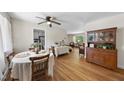 Sunlit dining area with hardwood floors, ceiling fan, and stylish hutch at 905 Aversboro Rd, Garner, NC 27529