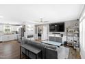 Spacious living room with modern gray furniture, an adjacent fireplace and an open floor plan at 10 Wilders Ln, Louisburg, NC 27549