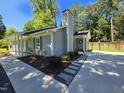Exterior view featuring a pathway to the home's side entrance with a fenced backyard at 1016 Buckhorn Rd, Garner, NC 27529
