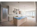 Spacious kitchen featuring a large island, modern pendant lighting, and plenty of natural light at 1112 Delilia Ln, Wake Forest, NC 27587