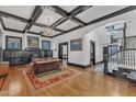 Spacious living room featuring hardwood floors, coffered ceilings, and a cozy fireplace at 118 N 7Th St, Smithfield, NC 27577