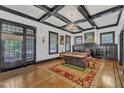 Inviting living room with fireplace, decorative ceiling, hardwood floors, and ample natural light at 118 N 7Th St, Smithfield, NC 27577