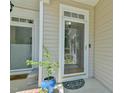 Close-up view of the home's main entrance with a glass storm door and sidelight window at 119 Jones Creek Place Pl # 119, Chapel Hill, NC 27516