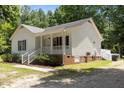 This beautiful home features white siding, a porch, and well maintained grounds at 119 Percheron Dr, Zebulon, NC 27597