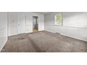 Neutral bedroom featuring carpet flooring, white trim, and a large window at 1402 Tarleton Ave, Burlington, NC 27215