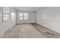Neutral bedroom featuring carpet flooring, white trim, and a large window at 1402 Tarleton Ave, Burlington, NC 27215