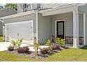 Charming home with a two-car garage, lovely landscaping, and a welcoming entrance at 154 Taverners Ln, Angier, NC 27501
