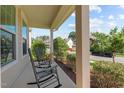 Cozy front porch with rocking chairs and a view of the serene neighborhood at 2120 Rainy Lake St, Wake Forest, NC 27587