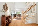 Open foyer featuring hardwood floors, a staircase and views into the living spaces at 219 W Columbia Pl, Chapel Hill, NC 27516