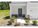 Close-up of a home's entrance with a stylish front door and stone accents at 224 Ivy Bank Dr, Angier, NC 27501