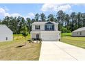 View of a charming two-story home with a two-car garage and landscaped front yard at 224 Ivy Bank Dr, Angier, NC 27501