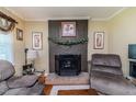 Close up view of a brick fireplace, complete with decorative accents and comfortable armchairs, perfect for relaxation at 233 Pressly Foushee Rd, Sanford, NC 27330