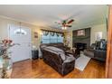 Cozy living room featuring hardwood floors, a brick fireplace, comfortable seating, and lots of natural light at 233 Pressly Foushee Rd, Sanford, NC 27330