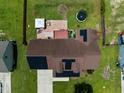 Aerial view of a well-maintained home featuring solar panels and a cozy backyard setup at 236 Emma Ct, Linden, NC 28356