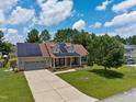 Charming two-story home with a well-manicured lawn, solar panels, and a spacious two-car garage at 236 Emma Ct, Linden, NC 28356