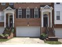 Attractive brick townhome exterior with garage and welcoming front entrance at 2507 Princewood St, Raleigh, NC 27612