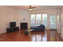 Bright living room featuring hardwood floors, a fireplace, and plenty of natural light through the windows at 2507 Princewood St, Raleigh, NC 27612