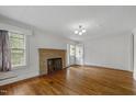 Inviting living room with brick fireplace and hardwood floors at 2715 E Geer St, Durham, NC 27704