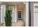 Inviting entryway with neutral walls, a dark wood door, and a welcoming doormat at 3215 Retama, New Hill, NC 27562
