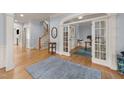 Elegant foyer featuring hardwood floors, staircase, and arched doorway to the office at 3306 Storybook Ln, Raleigh, NC 27614