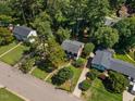 Aerial view of a well-maintained home with mature trees in a quiet neighborhood at 3317 Harden Rd, Raleigh, NC 27607