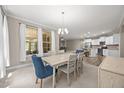 Bright, open-concept dining room featuring a modern chandelier and lots of natural light at 35 Clubhouse Dr, Youngsville, NC 27596