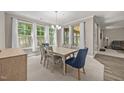 Elegant dining room with large windows, natural lighting, and neutral color palette at 35 Clubhouse Dr, Youngsville, NC 27596