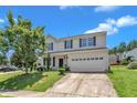 Two-story home with two-car garage and landscaping, showcasing curb appeal on a sunny day at 3604 Rivermist Dr, Raleigh, NC 27610