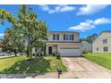 Lovely two-story home with a well-maintained lawn, mature tree, and a two-car garage at 3604 Rivermist Dr, Raleigh, NC 27610