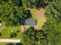 Aerial view of a secluded home nestled amongst mature trees on a spacious lot at 37 Weeping Willow Ln, Lillington, NC 27546