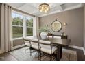 The dining room has stylish decor, a chandelier, a large window, and neutral colors that create an inviting atmosphere at 380 Shelby Meadow Ln, Angier, NC 27501