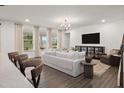 Open-concept living room featuring a large sofa, contemporary furnishings, and great natural lighting at 380 Shelby Meadow Ln, Angier, NC 27501