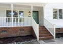 Welcoming front porch with brick base and white railing, leading to the home's entrance at 409 Glaive Dr, Durham, NC 27703