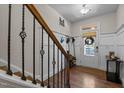 Welcoming foyer featuring hardwood floors, decorative railing, and natural light at 417 Austin View Blvd, Wake Forest, NC 27587