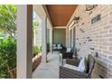 Inviting front porch with seating area, brick accents, and outdoor lighting at 417 Austin View Blvd, Wake Forest, NC 27587