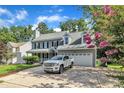 Well-maintained two-story home with an attached garage, concrete driveway, and landscaping at 4309 Birmingham Way, Raleigh, NC 27604