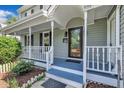Inviting covered front porch with white railing and blue floor, perfect for enjoying the outdoors at 4309 Birmingham Way, Raleigh, NC 27604