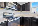 Close up of the kitchen featuring stainless steel oven and microwave, and white countertops at 46 Bellini Dr, Angier, NC 27501
