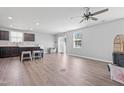 Spacious living room with wood-look flooring, ceiling fan, and sliding glass doors to the backyard at 46 Bellini Dr, Angier, NC 27501