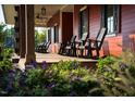 Inviting front porch with rocking chairs and lush landscaping at 48 Firefly Ln, Fuquay Varina, NC 27526
