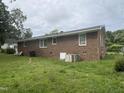 Brick ranch style house with white windows and a large backyard and central air conditioning at 503 Adams St, Henderson, NC 27536