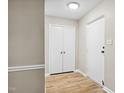 Bright entryway featuring neutral paint, wood floors, and convenient closet space at 5082 Flint Ridge Pl, Raleigh, NC 27609
