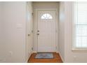 Bright foyer features hardwood floors, white door, and natural light from the window at 516 Yellow Berry, Wendell, NC 27591