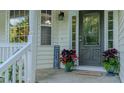 Front porch with a decorative door, manicured plants, and cozy welcome mat at 5307 Green Riley Rd, Rougemont, NC 27572