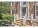 Close-up of the front entrance showing brick steps, white railings, and the address displayed above the door at 5328 Willow Cry Ln, Raleigh, NC 27613