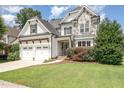 Charming two-story home featuring a stone facade, a three-car garage, and a well-manicured lawn at 5629 Clearsprings Dr, Wake Forest, NC 27587