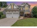 Charming two-story home featuring a stone facade, a three-car garage, and a well-manicured lawn at 5629 Clearsprings Dr, Wake Forest, NC 27587