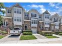 Charming townhome with stone accents, attached garages, and well-manicured landscaping, offering a desirable curb appeal at 5824 Cameo Glass Way, Raleigh, NC 27612